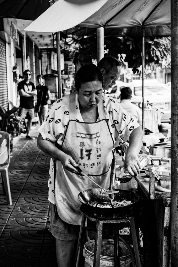 Woman adding seasoning