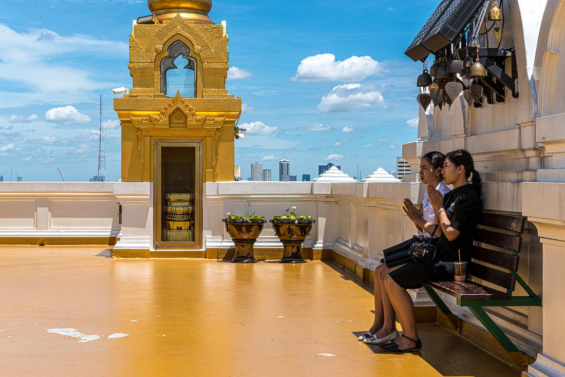 Two young women praying in Wat Saket