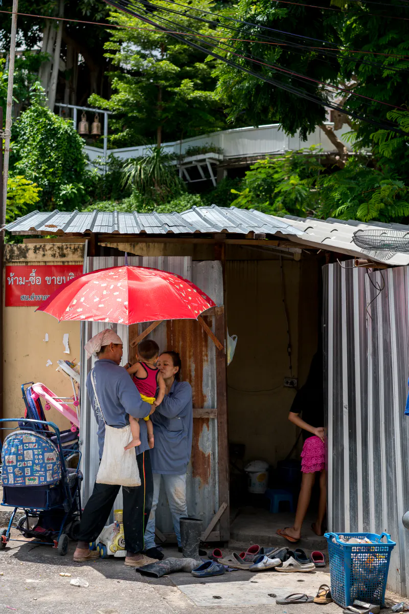日傘の下で抱っこされる赤ん坊