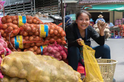 Young woman smiling with potato in hand