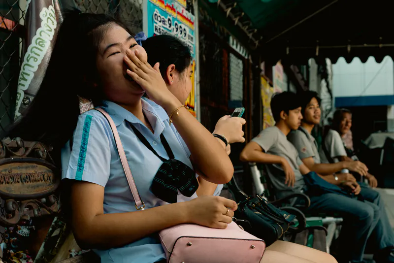 School girl laughing behind her hand