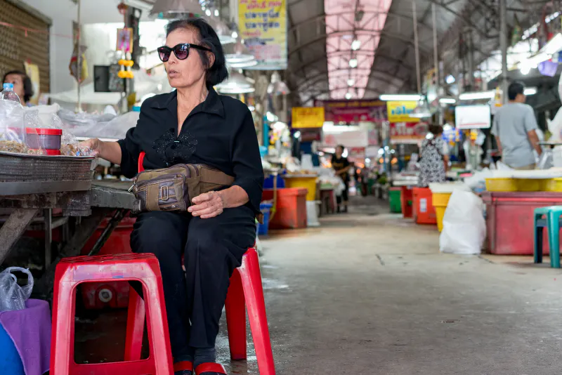 Shade-wearing woman in market