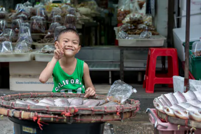 Boy selling dried fishes