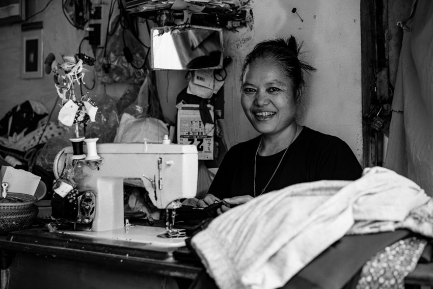 Woman working with power-operated sewing machine