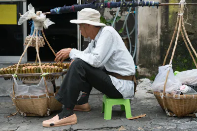 Street vendor doing business with carrying pole
