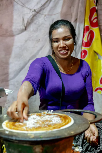 Woman cooking Mont Pyar Thalet at a food stall