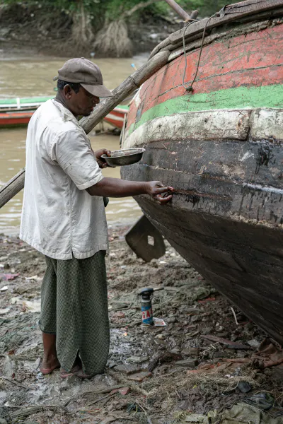 Man repairing fishing boat