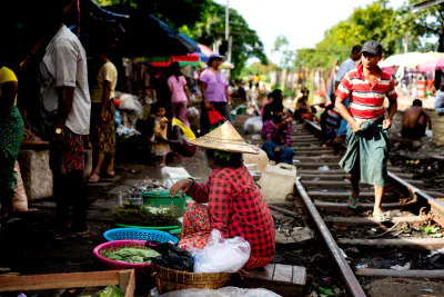Woman doing business beside railway track