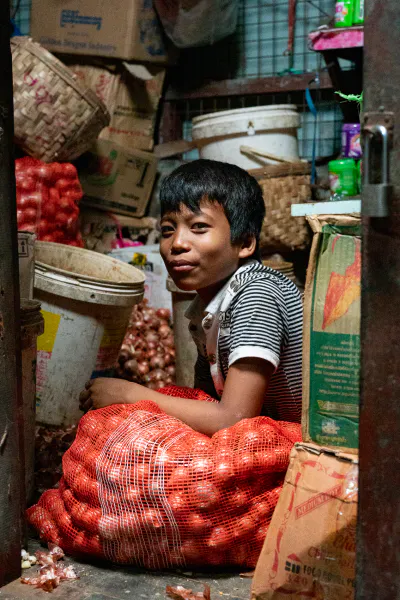 Boy surrounded by containers