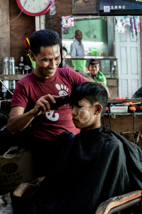 Barber cutting happily