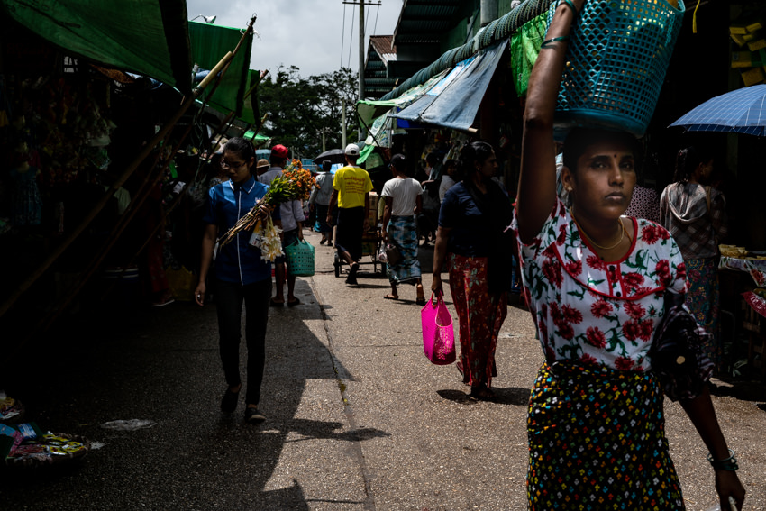 Woman walking with shopping bag on head