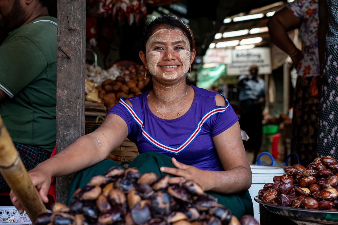 Smiling woman selling chestnuts