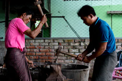 Blacksmiths beating with hammer