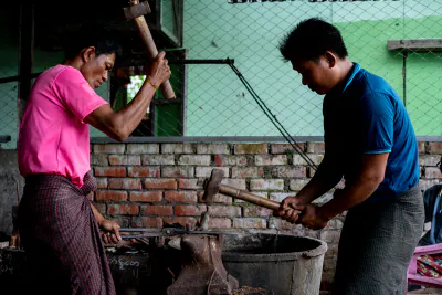 Blacksmiths beating with hammer