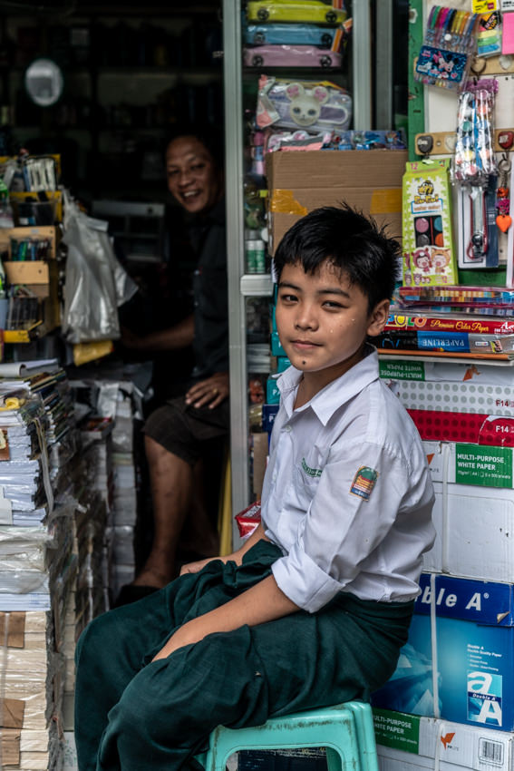 boy sitting in front of stationer
