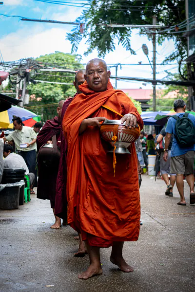 Buddhist monks carrying an alms bowl
