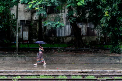 Woman walking platform with umbrella