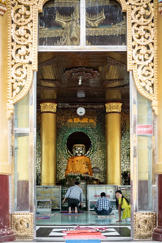 Buddha statue under clock