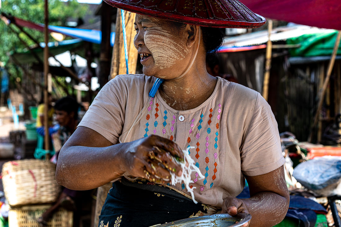 Woman cooking fried food in stall