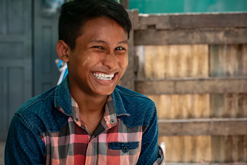 Young man smiling bashfully