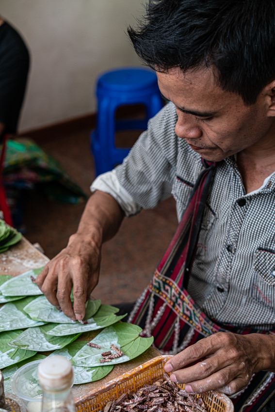Man putting betel nuts on betel leaves