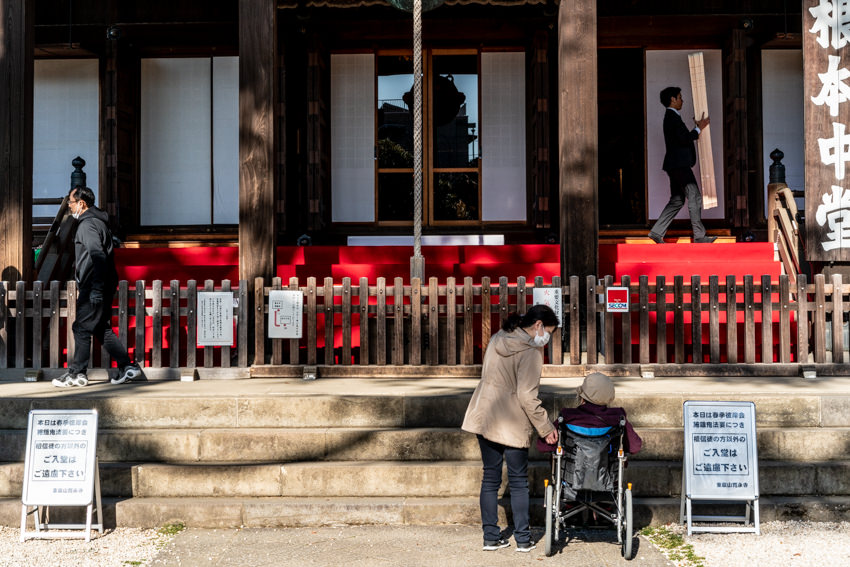 Worshippers praying in front of main hall called Konpon-Chudo