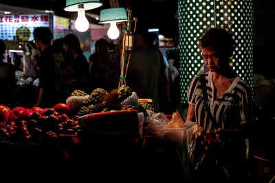 Older woman selling fruits in Linjiang Night Market