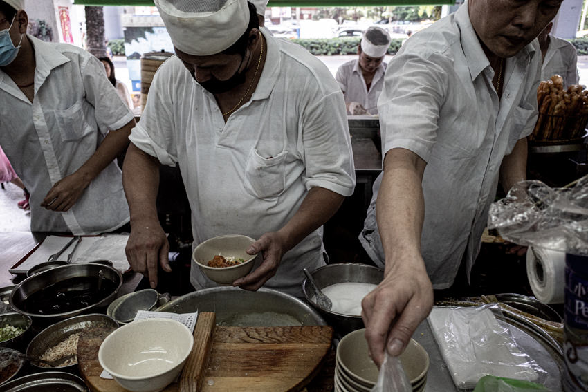 Men working in small busy kitchen