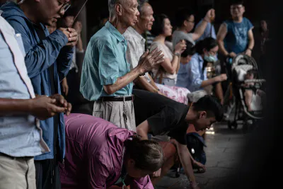 Many locals praying seriously in Lungshan Temple