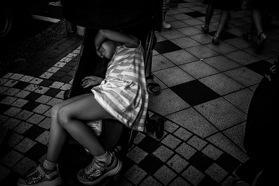 Exhausted little girl on baby buggy