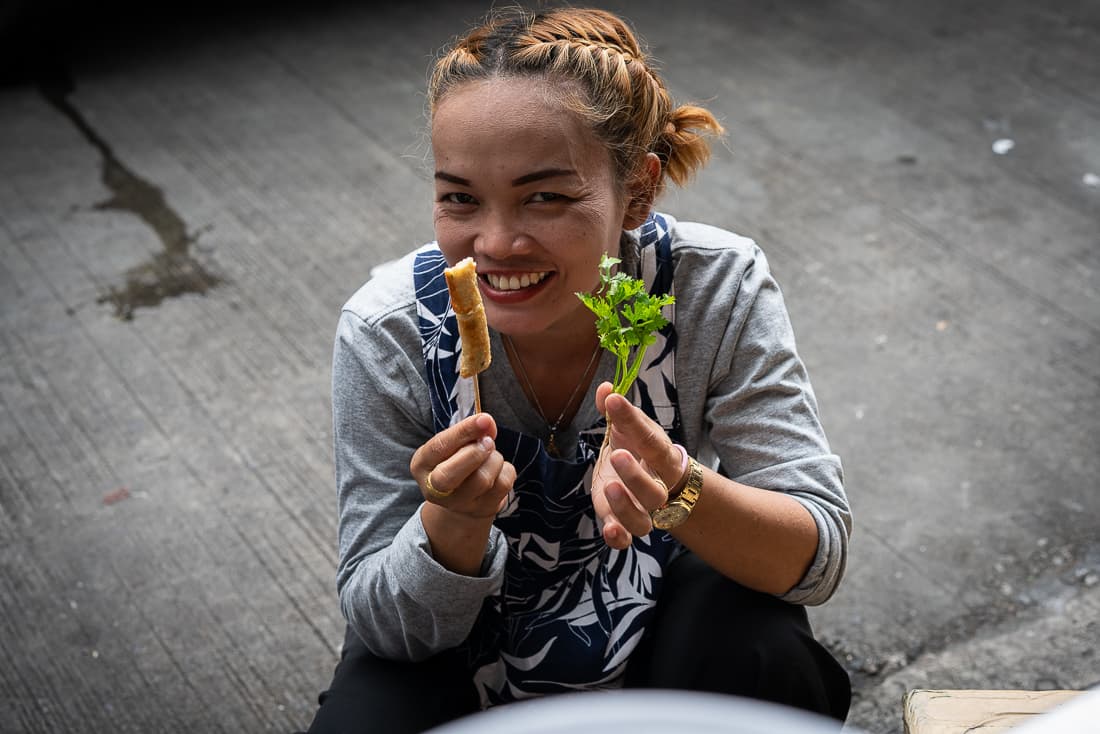 Woman with skewer and coriander