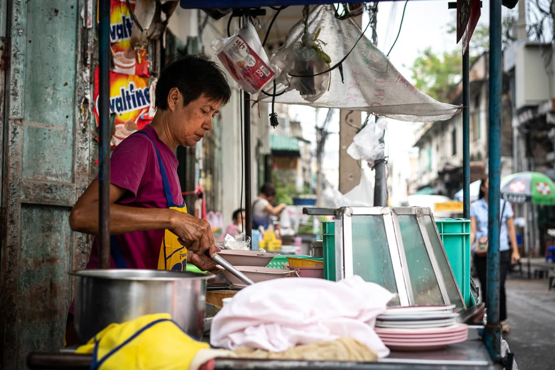 Woman cooking noodles in boiling water