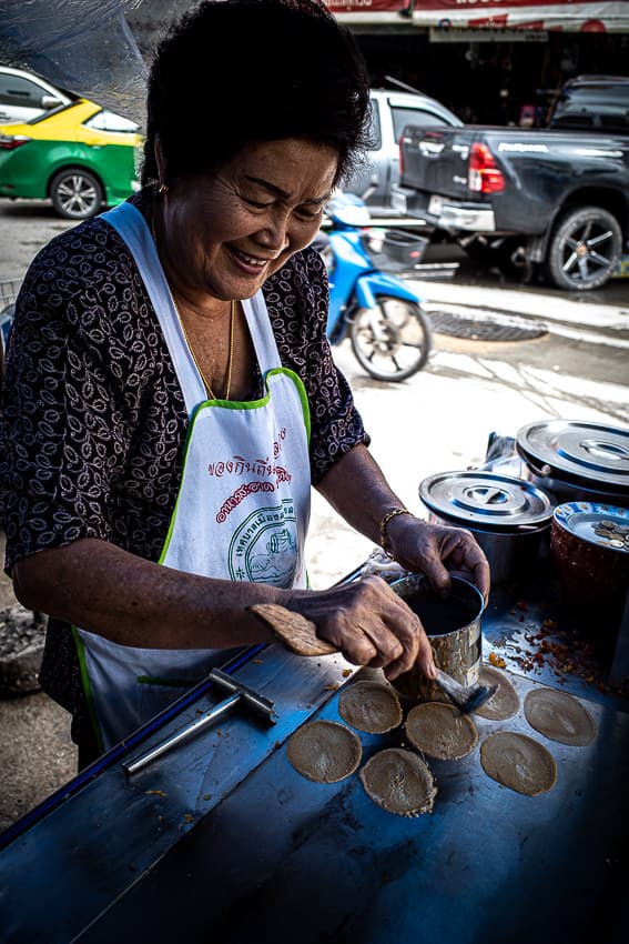 Woman cooking Khanom Bueang in a food stall