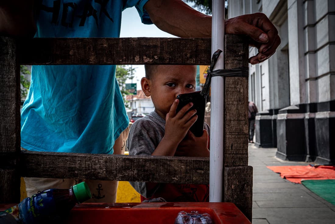 Little boy playing with a hand-held game console