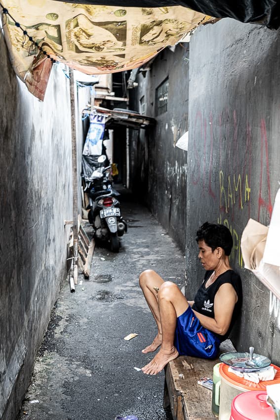 Shopkeeper resting in the lane in Jakarta