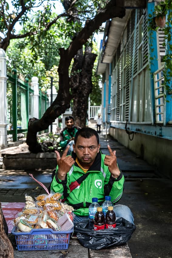 GOJEK driver resting in the tree shade