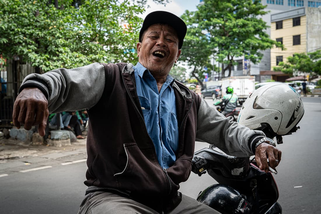 Motorbike taxi driver waiting for customers at an intersection