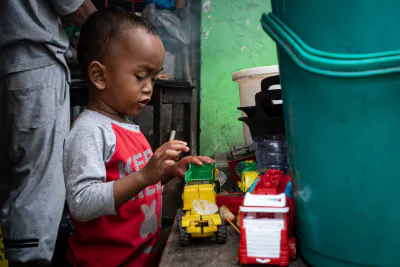 Little boy playing with working car toys
