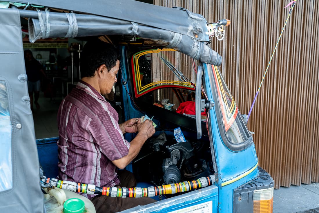 Man counting his money in Bajaj