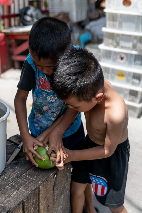 Boys eating a fruit in front of the temple