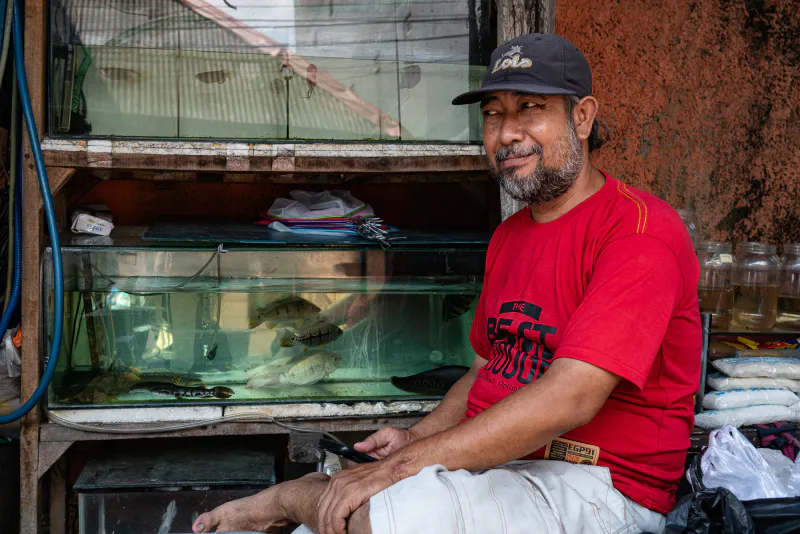 Man grinning in front of an aquarium