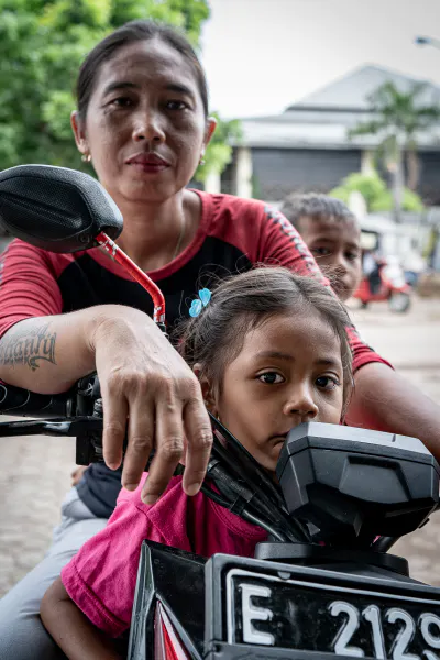 Mother and children riding a motorcycle together