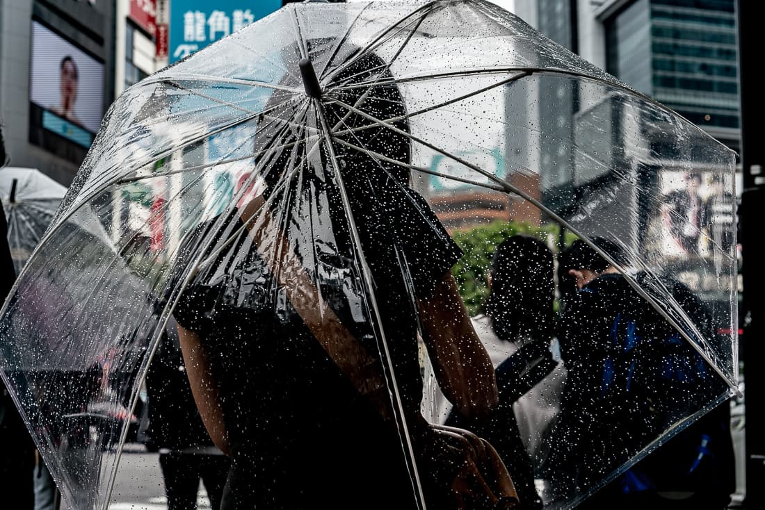 Young woman holding a plastic umbrella
