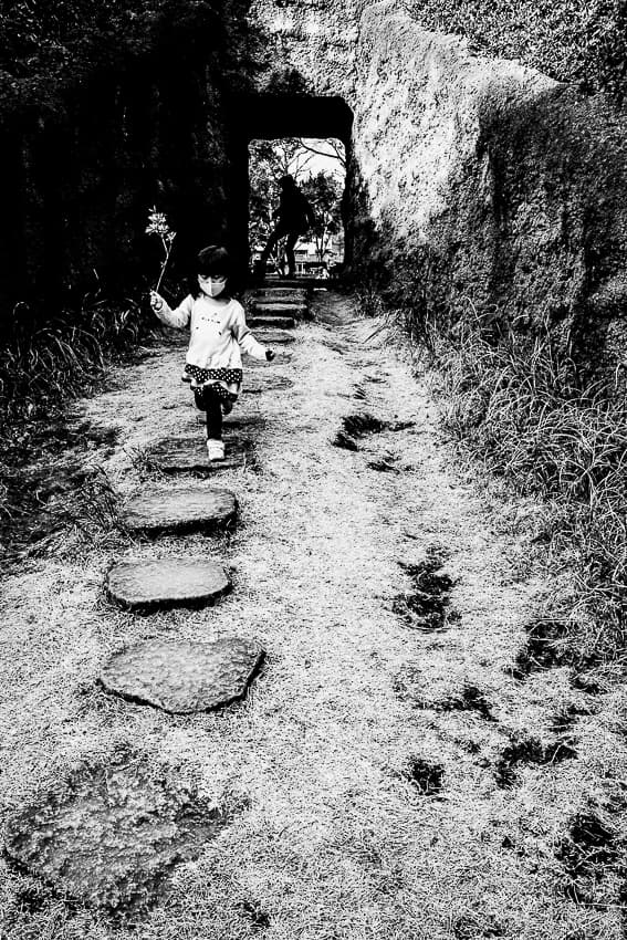 Girl running with a flower in her hand