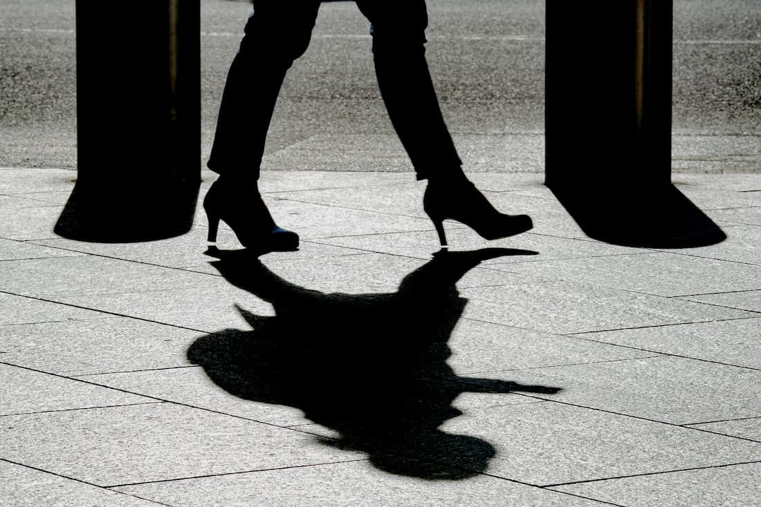 Silhouette walking briskly in high heels