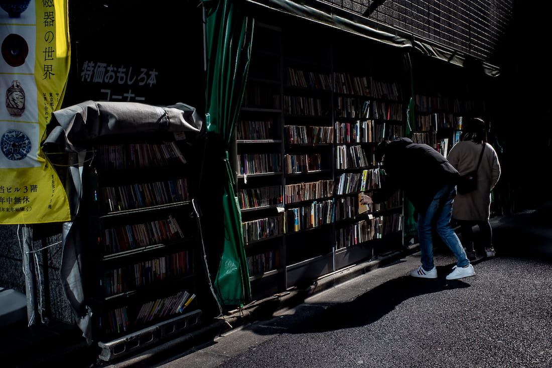 People scavenging at a secondhand bookstore