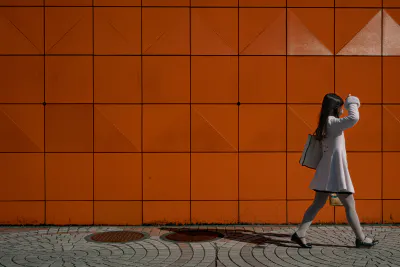 Young woman walking in front of Odakyu Department Store
