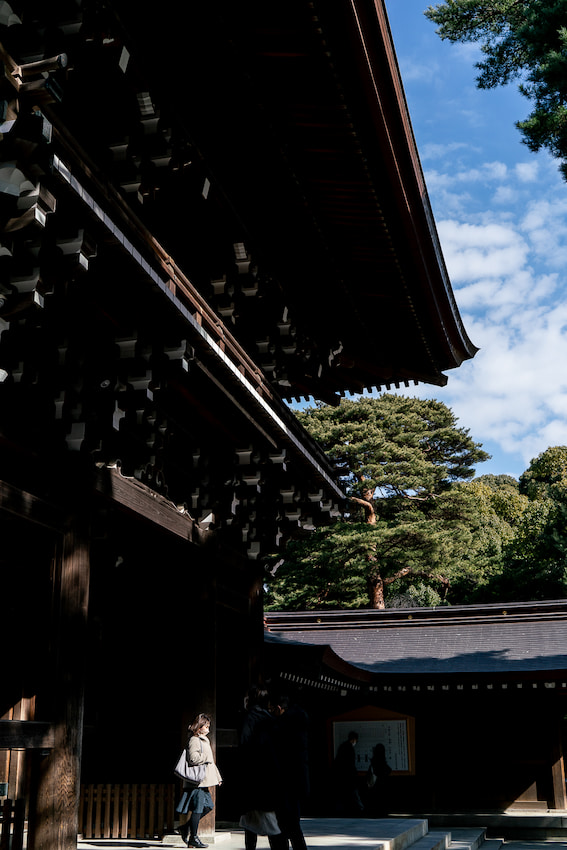 Woman passing through the gate of Meiji Jingu Shrine