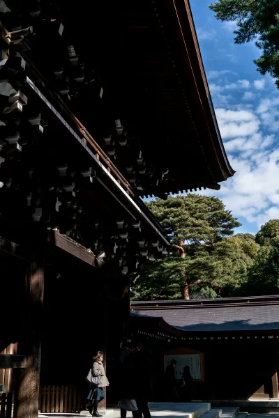 Woman passing through the gate of Meiji Jingu Shrine