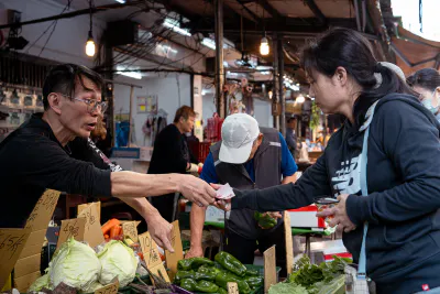 Woman receiving change at a grocery store